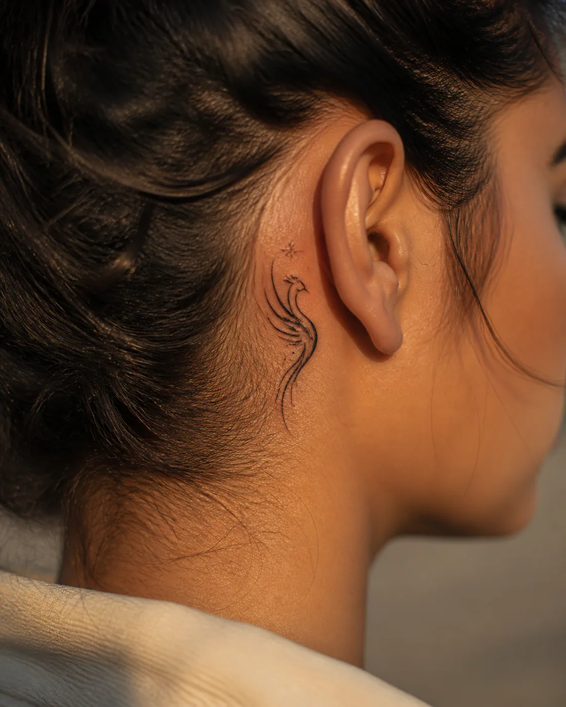 Minimalist Mythic tattoo on the Behind Ear