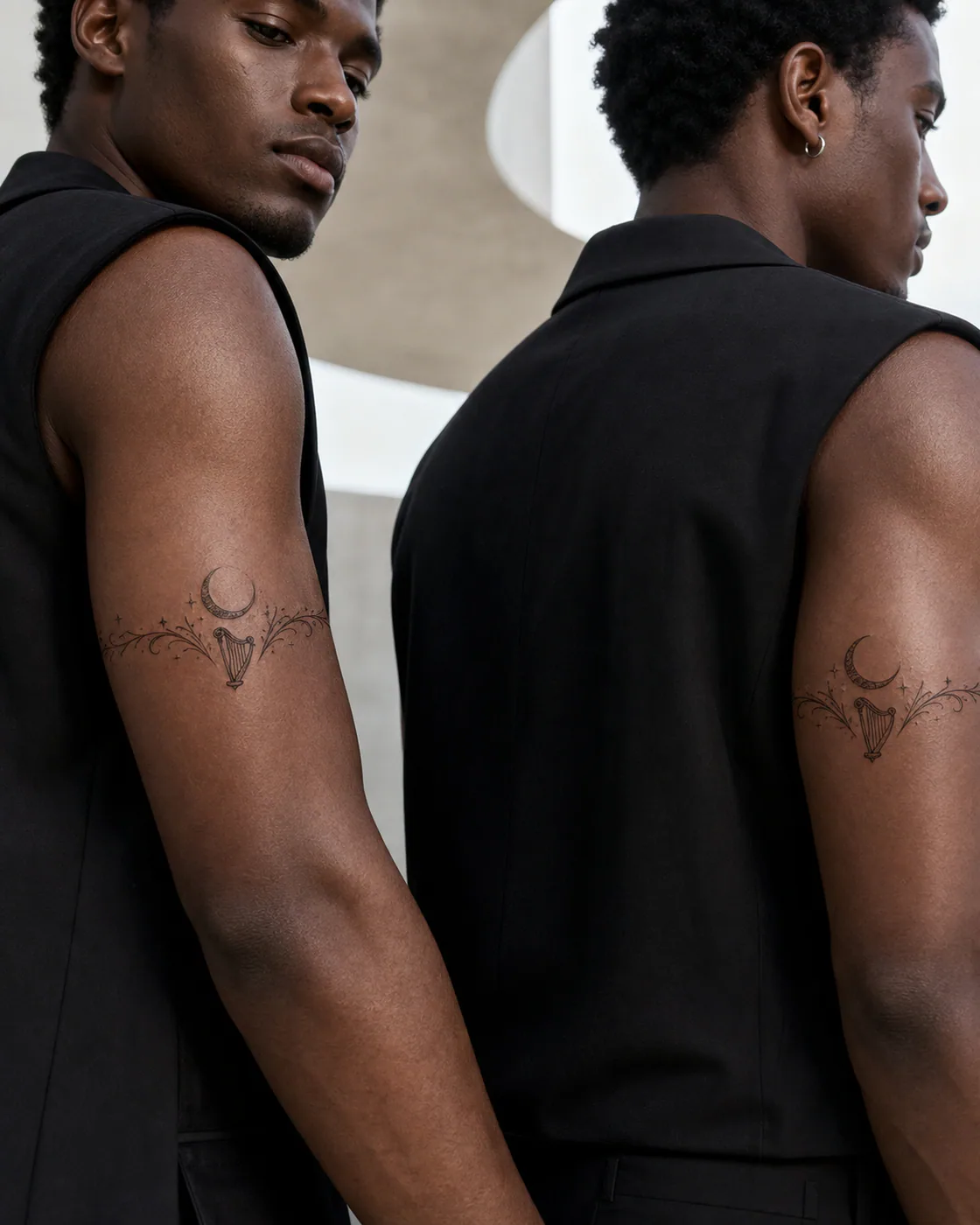 Illustrative tattoo of a small harp suspended beneath a crescent moon as a complementary couple tattoo pair on the armband