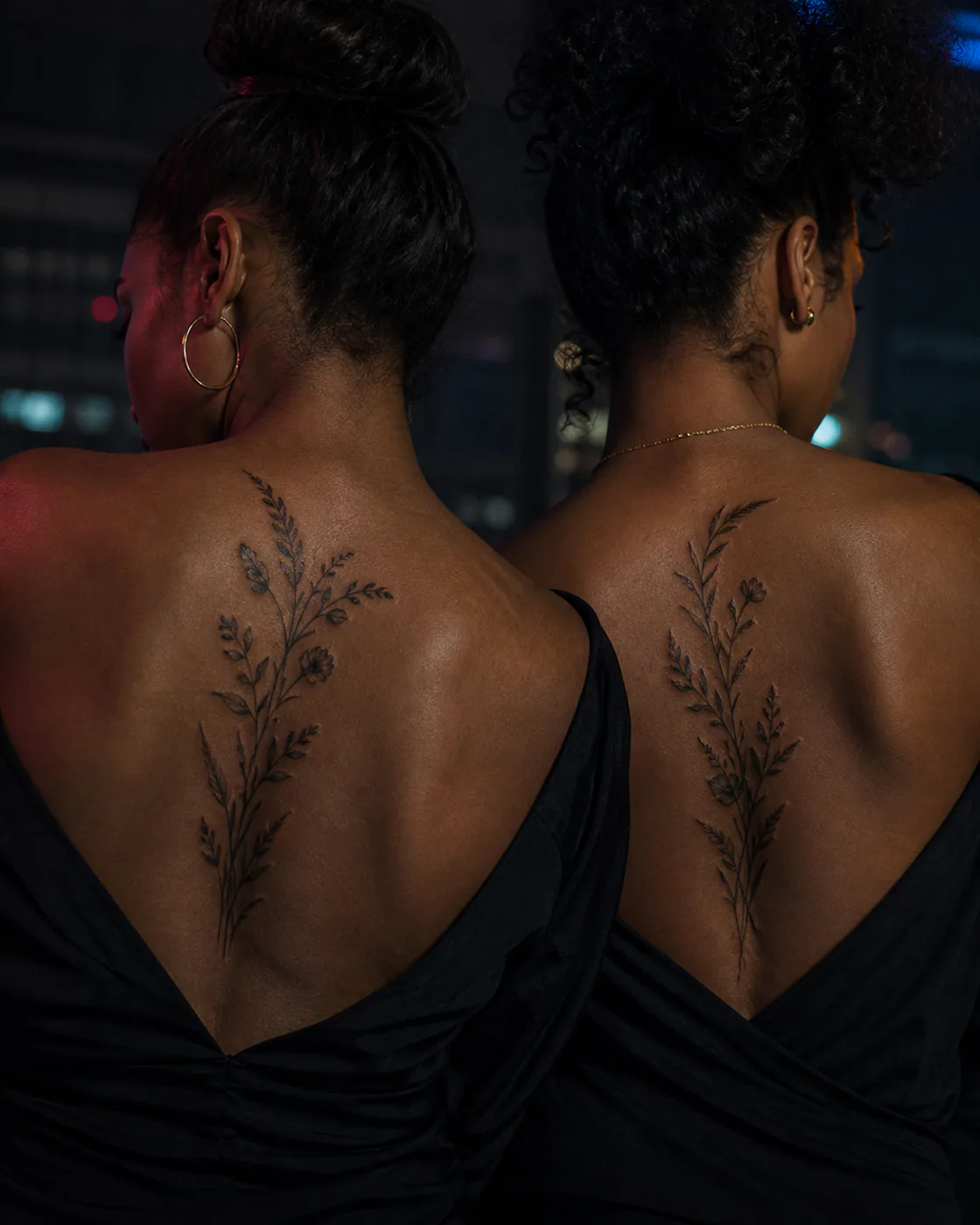 Black and Gray tattoo of willow herb and grasses bending in opposite directions as a complementary couple tattoo pair on the upper back