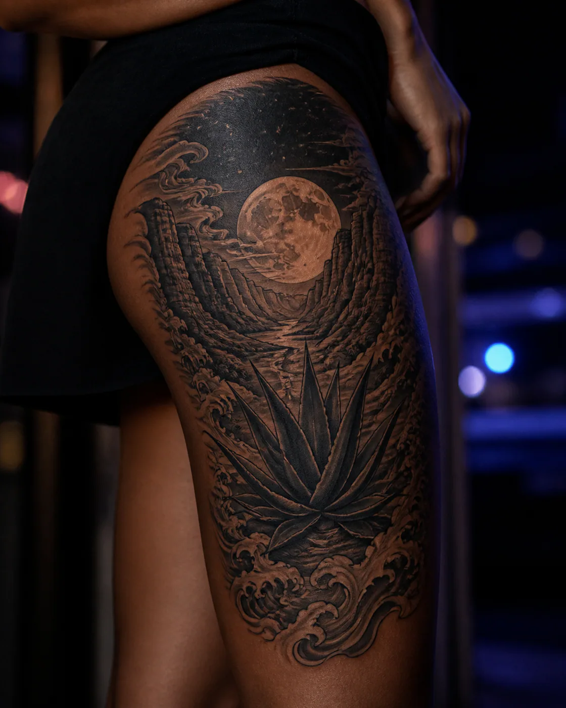 Japanese tattoo of a canyon moon rising behind a lone agave on the outer thigh