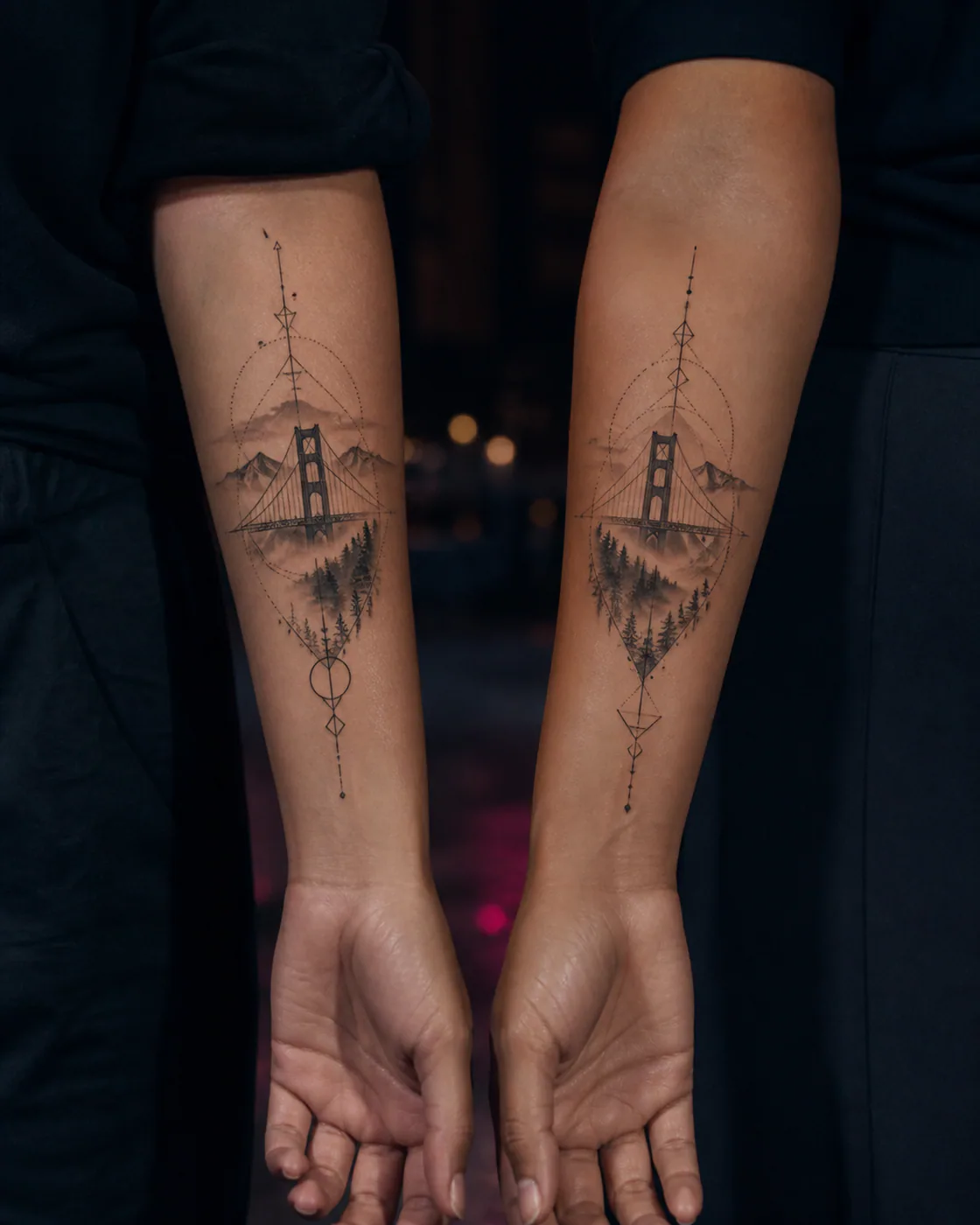 Geometric tattoo of a suspension bridge fading into mountain mist as a complementary couple tattoo pair on the forearm