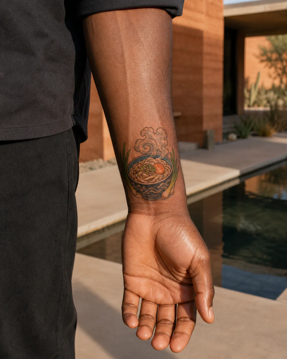 New School tattoo of a bowl of udon framed by scallions and rising steam on the wrist