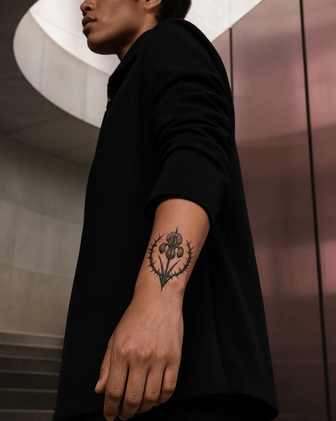 Blackwork tattoo of a thorn crown encircling a pale night-blooming iris with a three-part family motif on the wrist