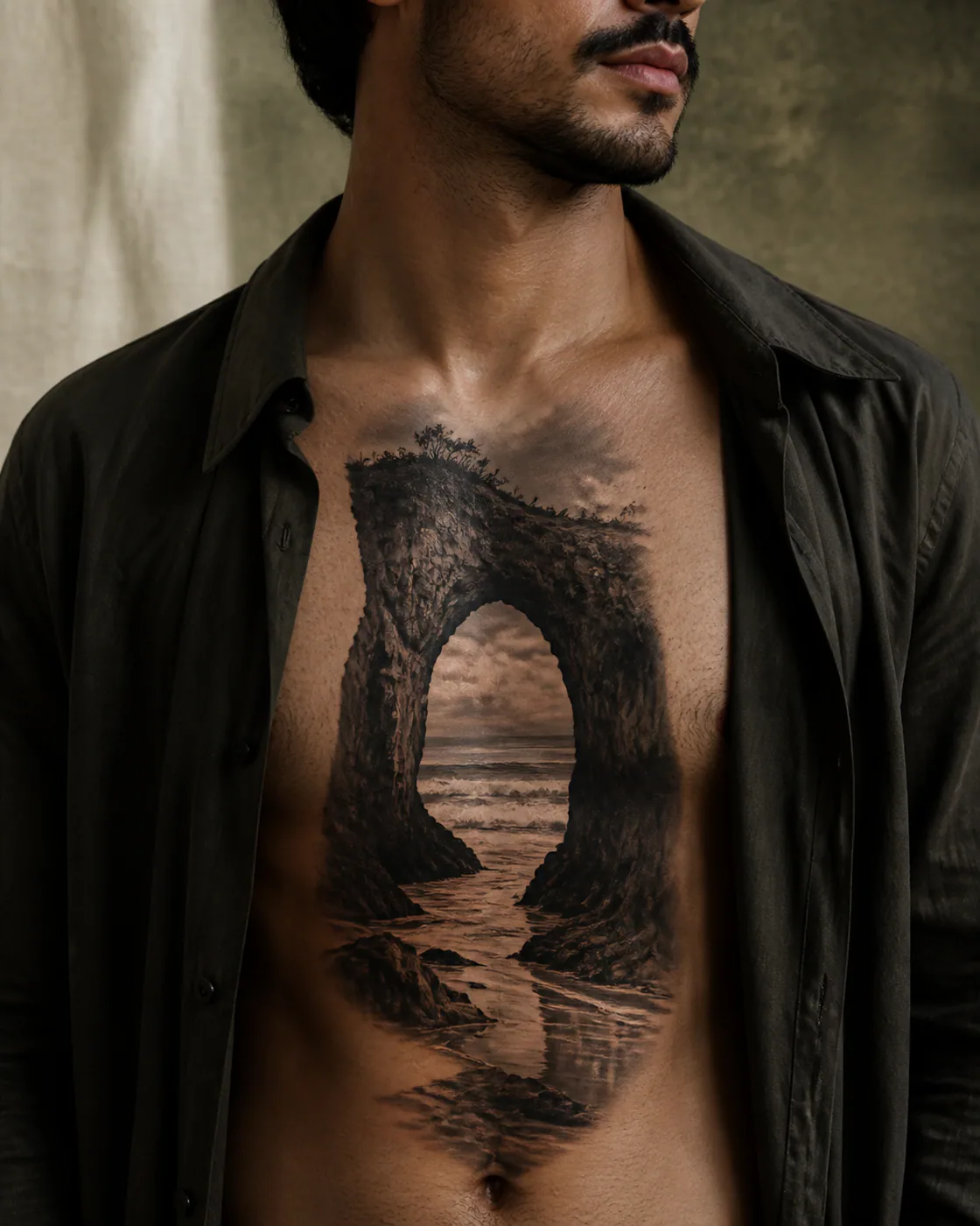Black and Gray tattoo of a sea arch holding a distant line of winter surf on the sternum