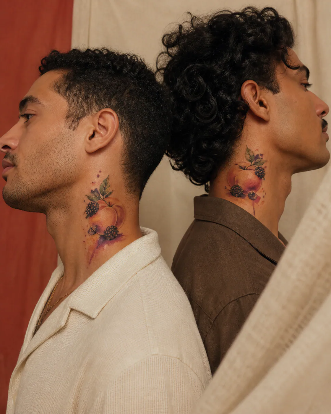 Watercolor tattoo of a peach and blackberry still life on folded linen as a complementary couple tattoo pair on the side of neck