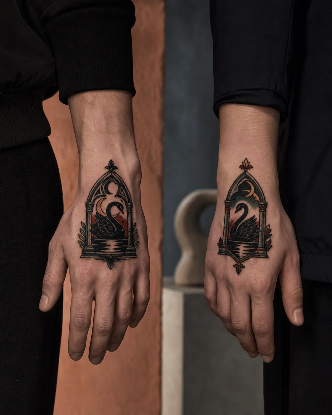 American Traditional tattoo of a gothic window and a black swan joined by reflected moonlight as a complementary couple tattoo pair on the back of hand