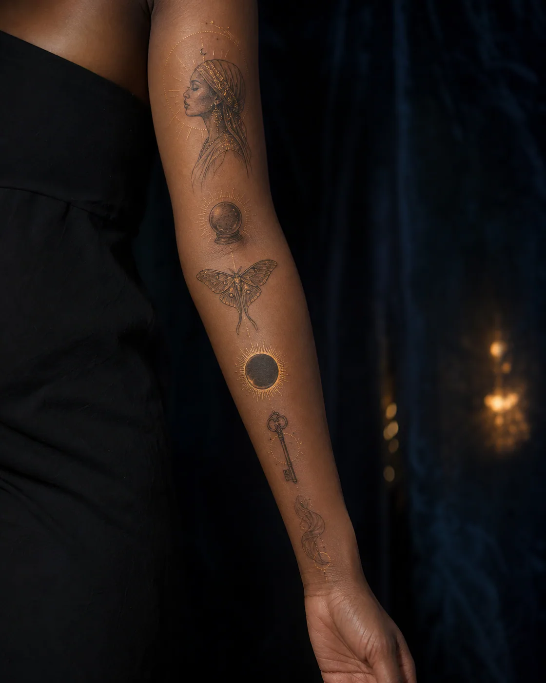 Fine-line mystical patchwork sleeve tattoo with a moon priestess, crystal orb, lunar moth, eclipse, key, and flowing veil on deep skin